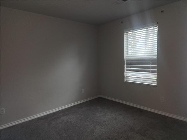 empty room with dark carpet