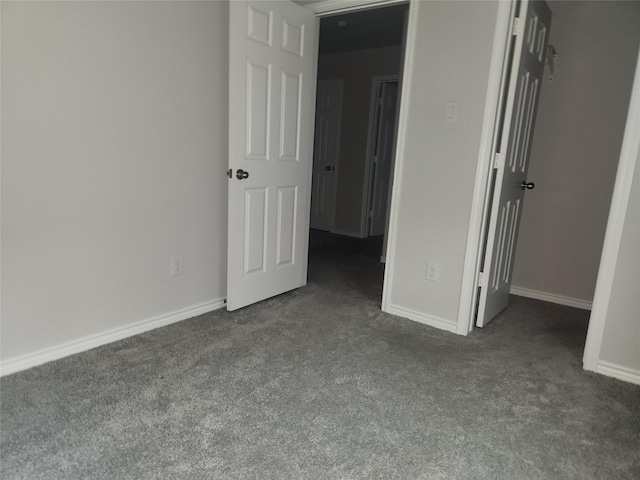 unfurnished bedroom featuring dark carpet