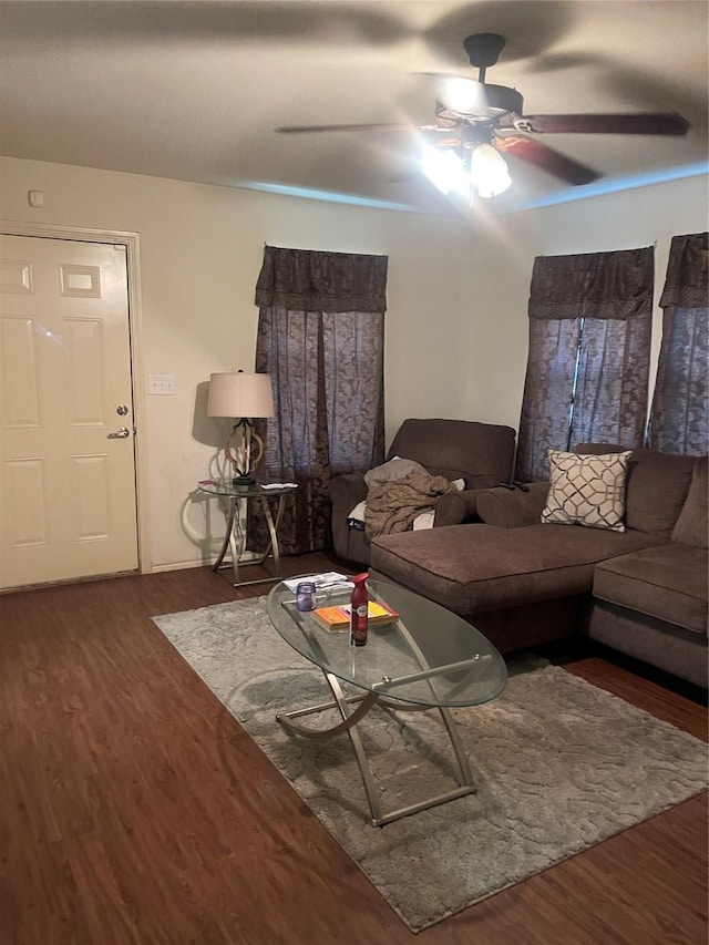 living room featuring dark hardwood / wood-style floors and ceiling fan