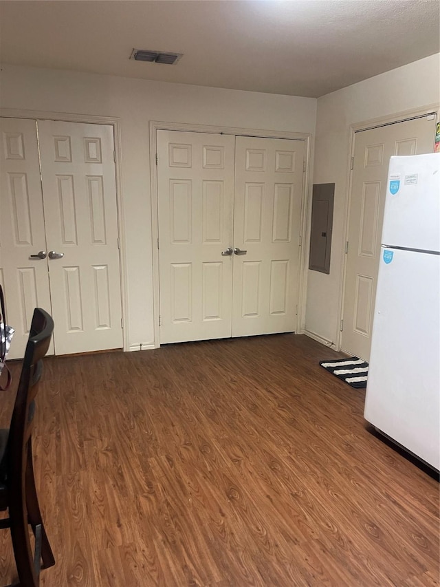 interior space featuring dark hardwood / wood-style floors and electric panel