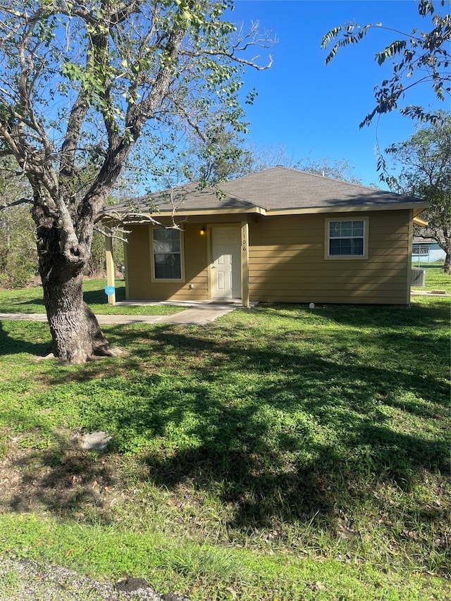 rear view of property with a yard