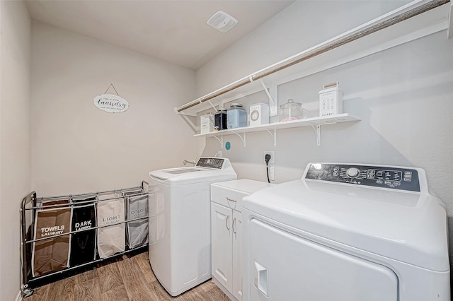 washroom featuring hardwood / wood-style flooring and independent washer and dryer