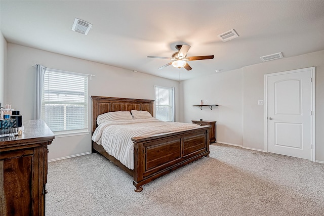 carpeted bedroom with ceiling fan and multiple windows