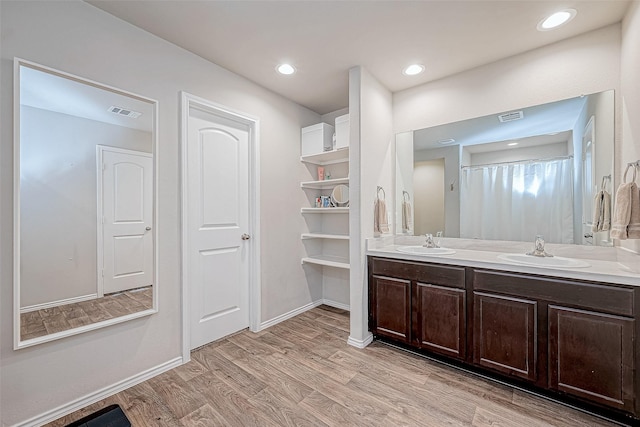 bathroom featuring vanity, hardwood / wood-style flooring, and walk in shower