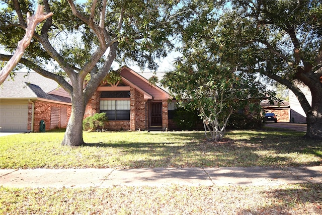 view of front of home with a garage and a front lawn