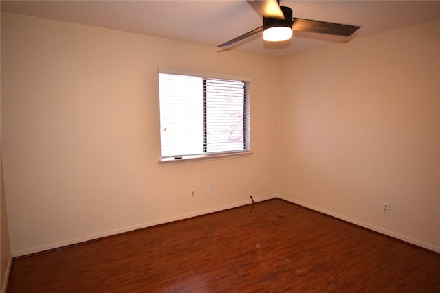 spare room with ceiling fan and dark hardwood / wood-style flooring