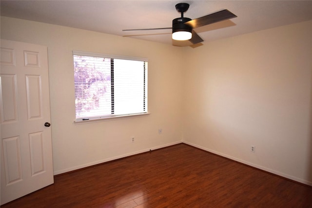 unfurnished room with dark hardwood / wood-style flooring and ceiling fan