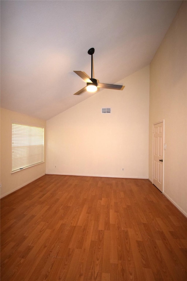 unfurnished room featuring ceiling fan, wood-type flooring, and vaulted ceiling