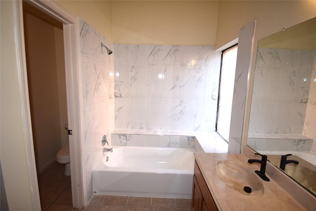 bathroom featuring a tub, tile patterned flooring, vanity, and toilet