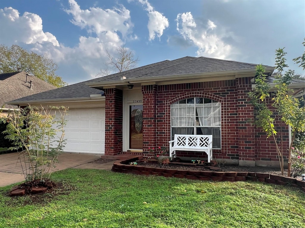 view of front of property with a garage and a front lawn