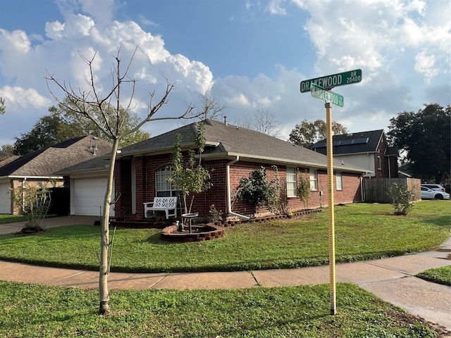 single story home featuring a garage and a front yard