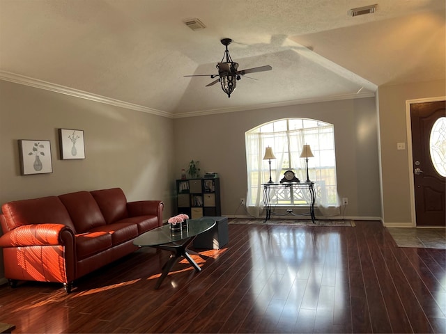 living room with a textured ceiling, vaulted ceiling, ceiling fan, dark wood-type flooring, and crown molding