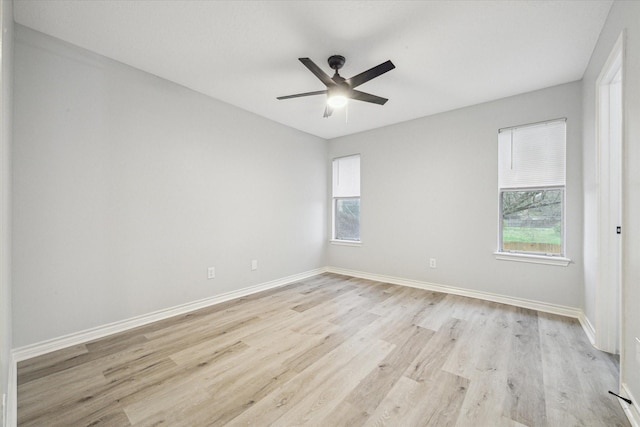 spare room with light hardwood / wood-style floors and ceiling fan