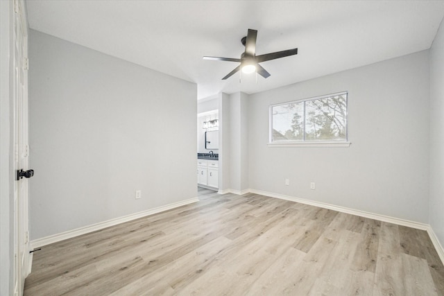 empty room featuring ceiling fan and light hardwood / wood-style floors