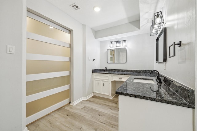 bathroom featuring hardwood / wood-style floors and vanity