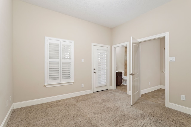 unfurnished bedroom featuring light carpet