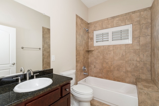 full bathroom with vanity, tiled shower / bath combo, and toilet