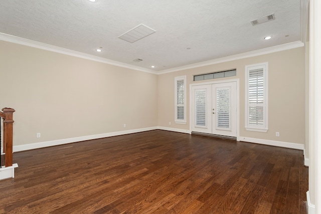 spare room with french doors, dark hardwood / wood-style flooring, a textured ceiling, and crown molding