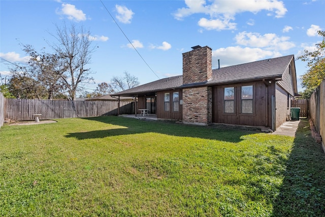 rear view of property with central AC unit and a lawn