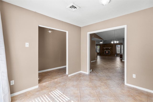 interior space featuring tile patterned floors, a brick fireplace, and ceiling fan