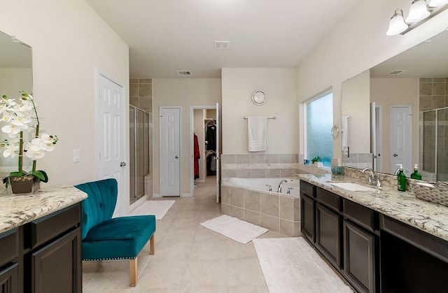 bathroom featuring separate shower and tub, tile patterned flooring, and vanity