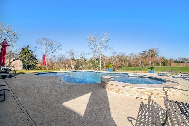 view of pool with a patio area and an in ground hot tub