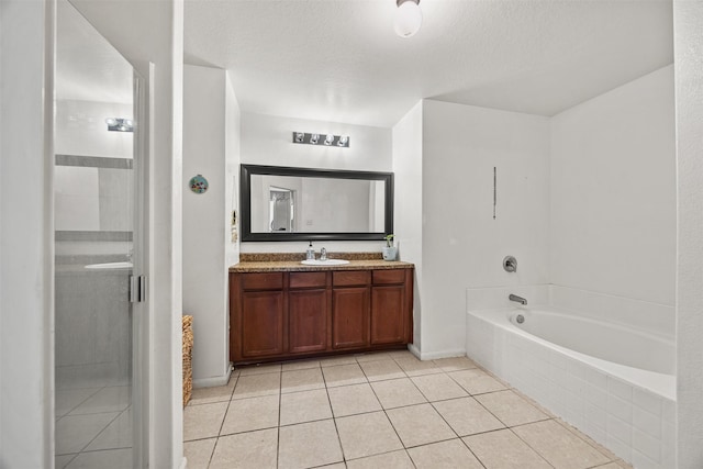 bathroom with tile patterned flooring, vanity, independent shower and bath, and a textured ceiling