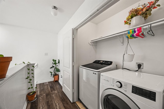 clothes washing area with dark hardwood / wood-style flooring and washing machine and dryer