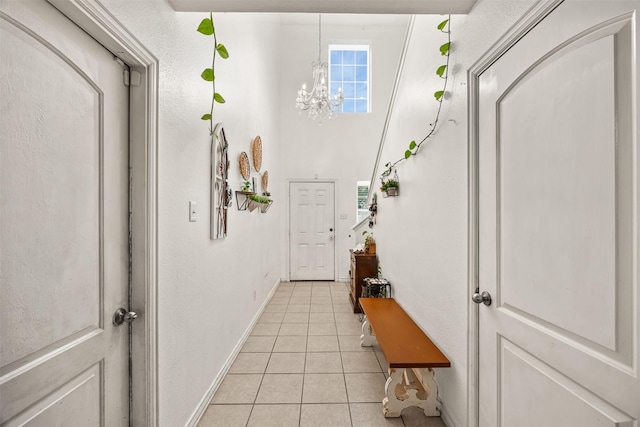 entryway featuring light tile patterned flooring and a chandelier