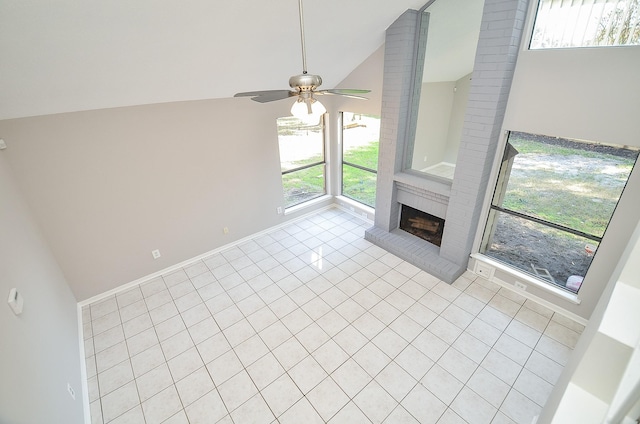 unfurnished living room featuring ceiling fan, light tile patterned flooring, high vaulted ceiling, and a brick fireplace