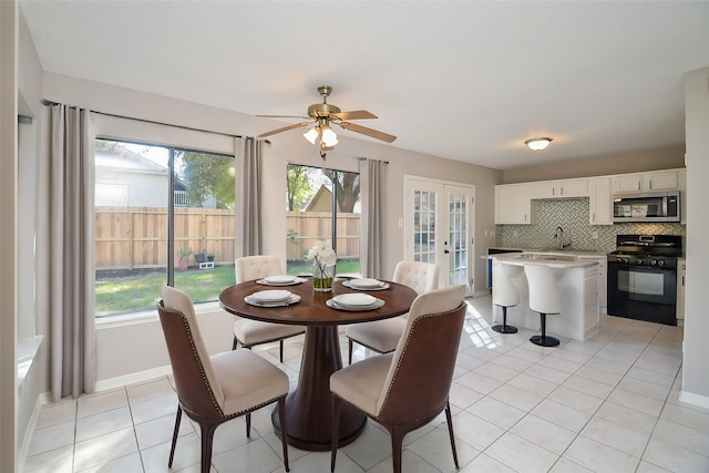 dining space featuring french doors, ceiling fan, and light tile patterned flooring