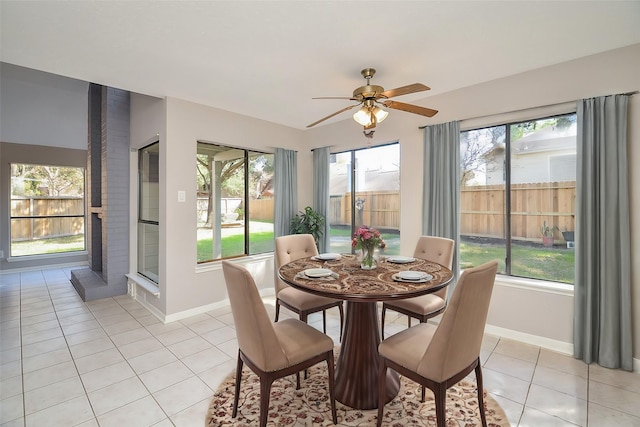 tiled dining space with ceiling fan