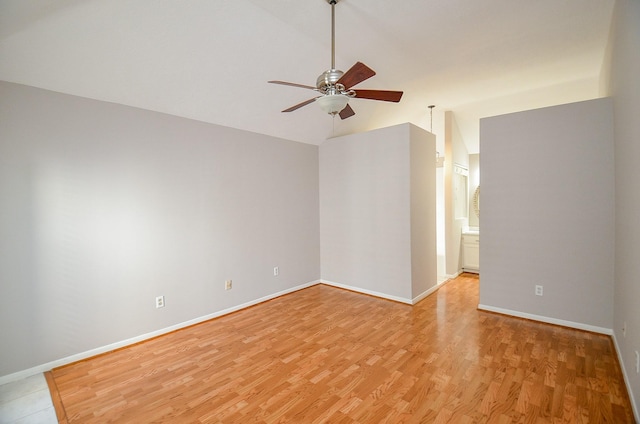 empty room featuring light hardwood / wood-style flooring, ceiling fan, and lofted ceiling