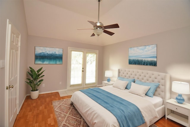 bedroom featuring ceiling fan, french doors, wood-type flooring, and vaulted ceiling