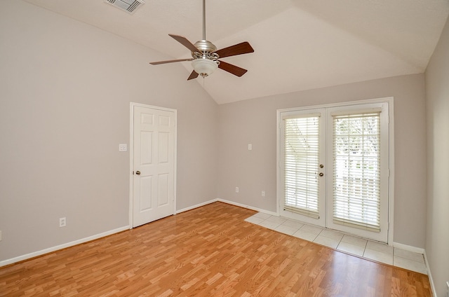 unfurnished room featuring ceiling fan, french doors, light hardwood / wood-style floors, and lofted ceiling