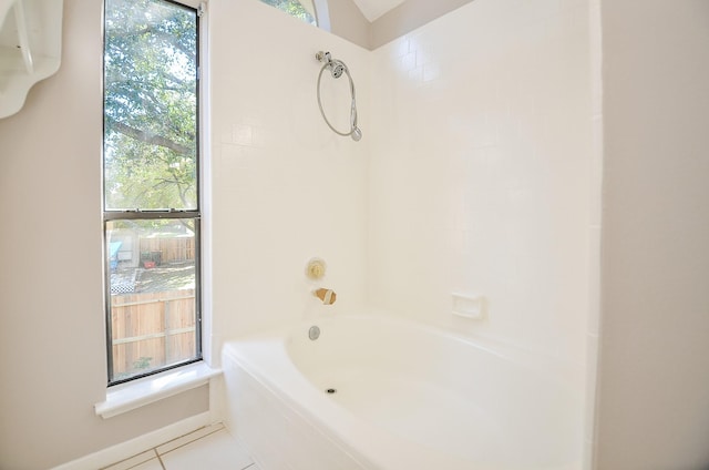 bathroom with tile patterned flooring, shower / bath combination, and a healthy amount of sunlight