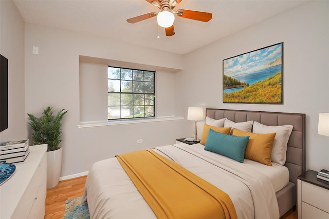 bedroom with ceiling fan and light hardwood / wood-style flooring