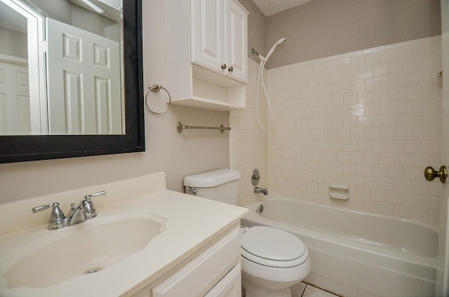 full bathroom featuring tiled shower / bath combo, toilet, and vanity