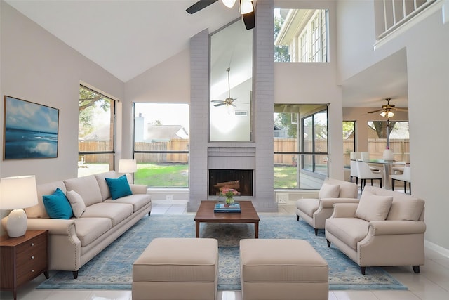 living room featuring light tile patterned floors, high vaulted ceiling, and a brick fireplace