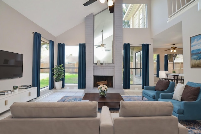 living room with a fireplace, high vaulted ceiling, and light tile patterned flooring