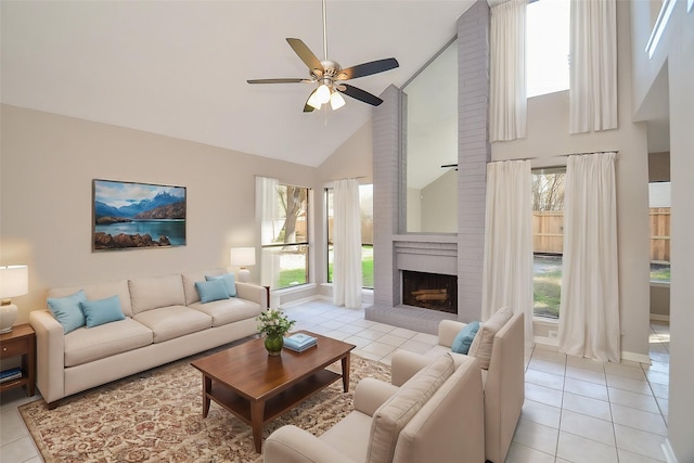 tiled living room featuring a brick fireplace, high vaulted ceiling, and ceiling fan