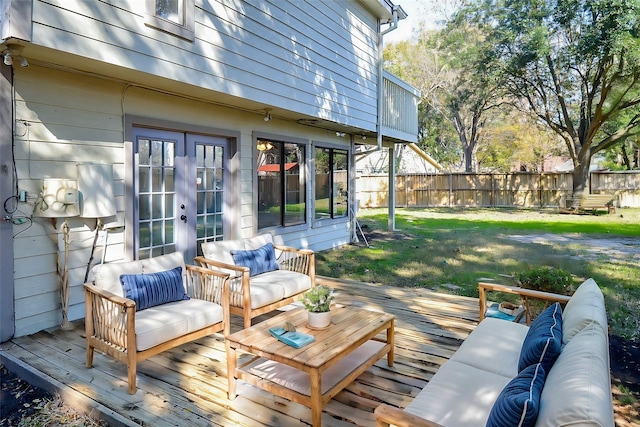 wooden deck featuring outdoor lounge area and a lawn