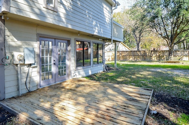 wooden deck featuring a lawn