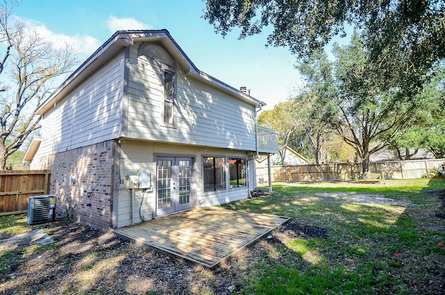 back of property featuring a lawn, french doors, and central AC unit