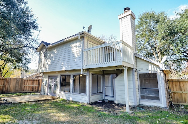 back of property featuring a deck and a patio area