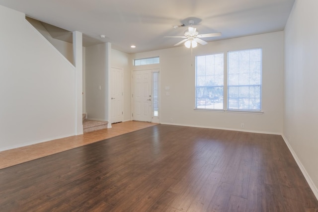 interior space with ceiling fan and dark hardwood / wood-style floors