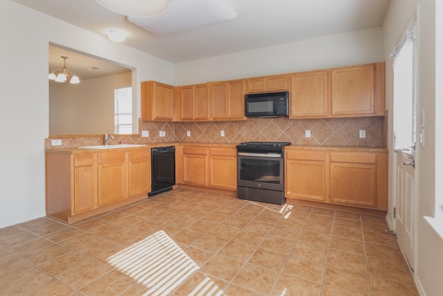 kitchen with backsplash, an inviting chandelier, black appliances, sink, and light tile patterned floors