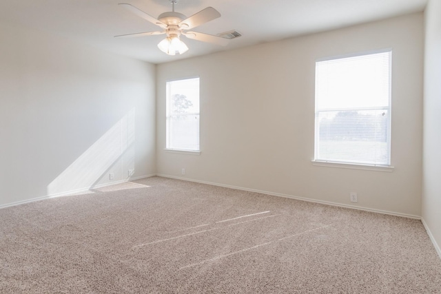 carpeted empty room featuring ceiling fan