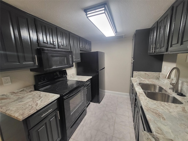 kitchen with light stone countertops, sink, black appliances, and a textured ceiling