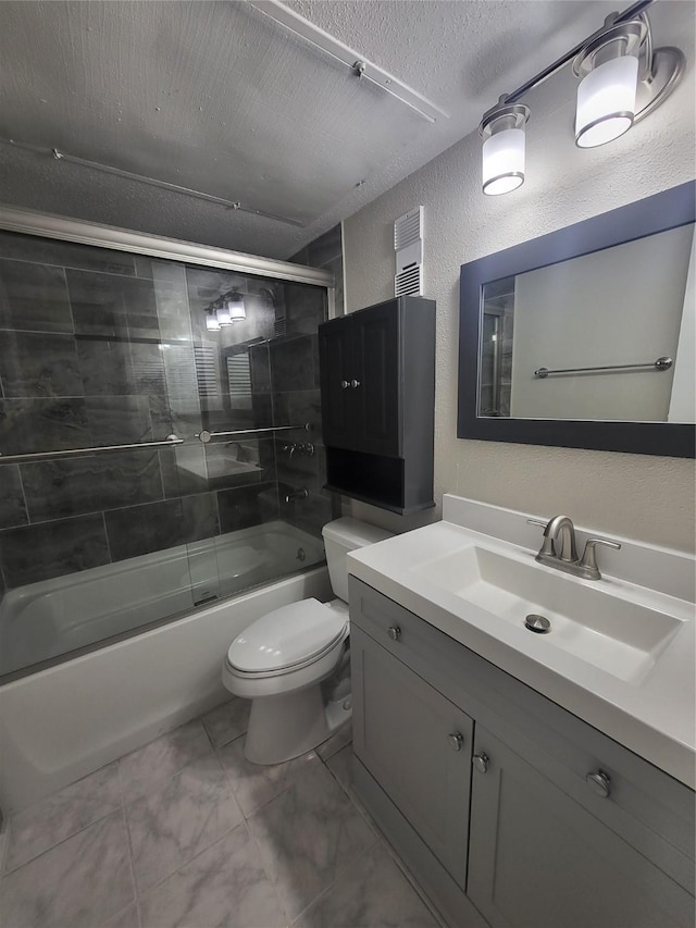 full bathroom featuring vanity, a textured ceiling, toilet, and enclosed tub / shower combo